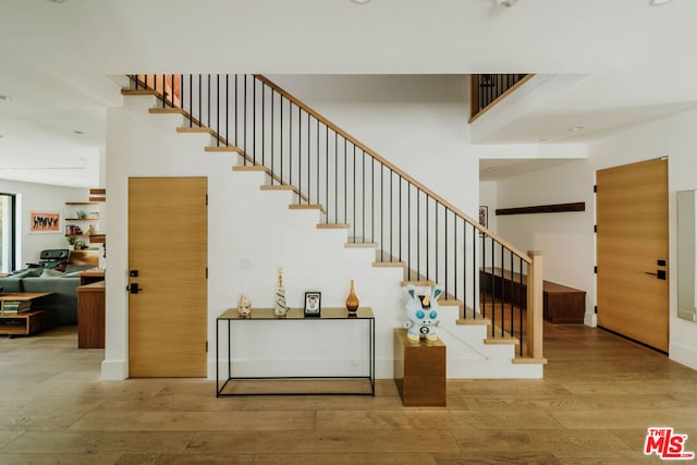 staircase featuring wood-type flooring