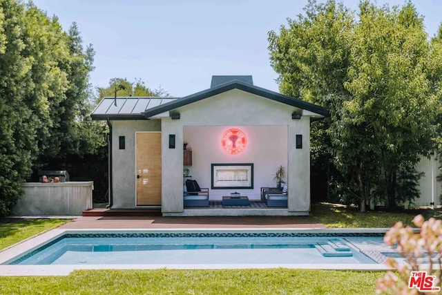 rear view of property featuring a pool side deck