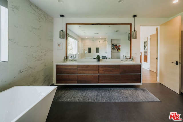 bathroom with a tub to relax in, hardwood / wood-style floors, and vanity