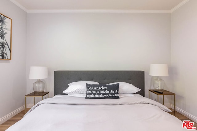 bedroom featuring crown molding and hardwood / wood-style flooring