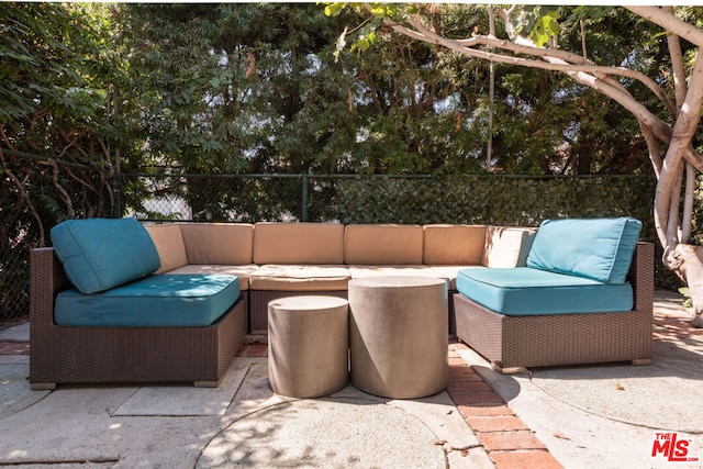 view of patio / terrace with an outdoor living space with a fire pit