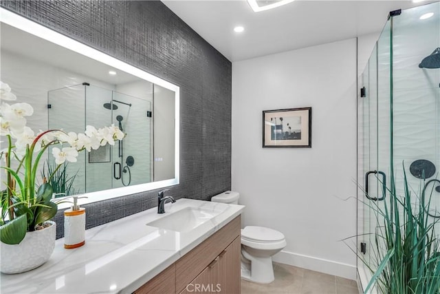 bathroom featuring tile patterned flooring, vanity, an enclosed shower, and toilet