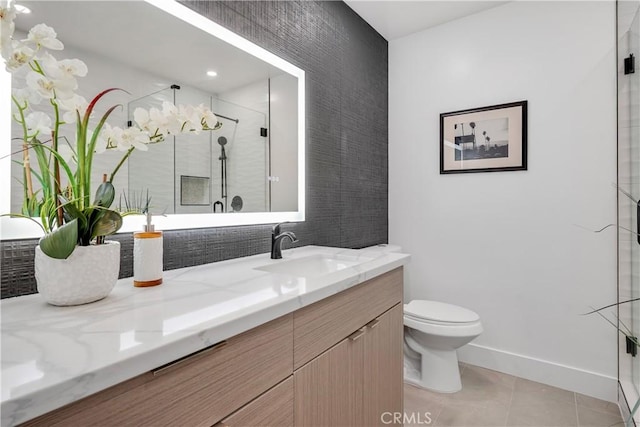 bathroom featuring tile patterned floors, toilet, vanity, and walk in shower