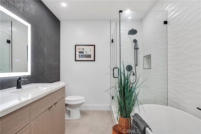 full bathroom with tile patterned floors, separate shower and tub, vanity, and toilet