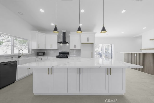 kitchen with white cabinets, pendant lighting, wall chimney range hood, black appliances, and a spacious island