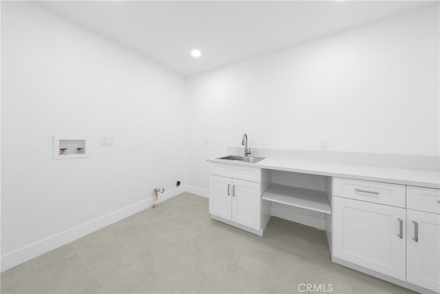 clothes washing area with hookup for a gas dryer, sink, washer hookup, and cabinets