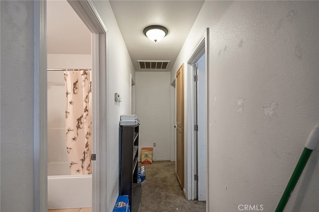 hall featuring light colored carpet