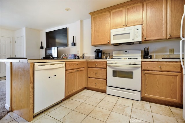 kitchen featuring white appliances and light tile patterned floors