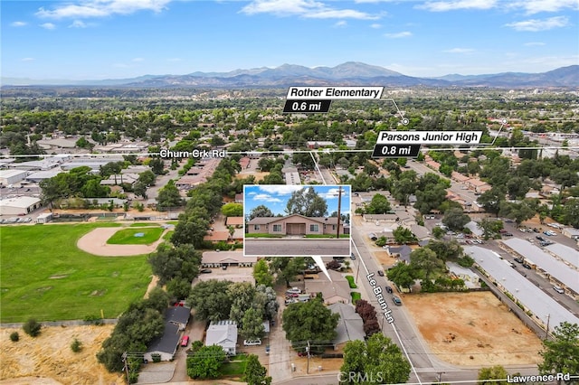 birds eye view of property featuring a mountain view