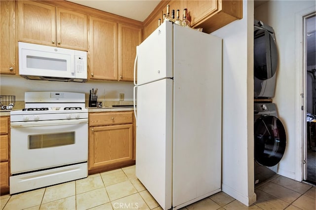 kitchen featuring stacked washer and clothes dryer, white appliances, and light tile patterned floors