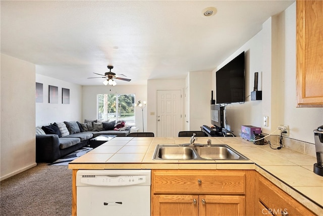 kitchen with white dishwasher, tile countertops, carpet flooring, and sink