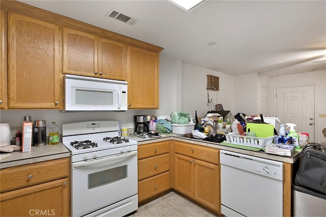 kitchen with white appliances, ceiling fan, light tile patterned floors, and sink