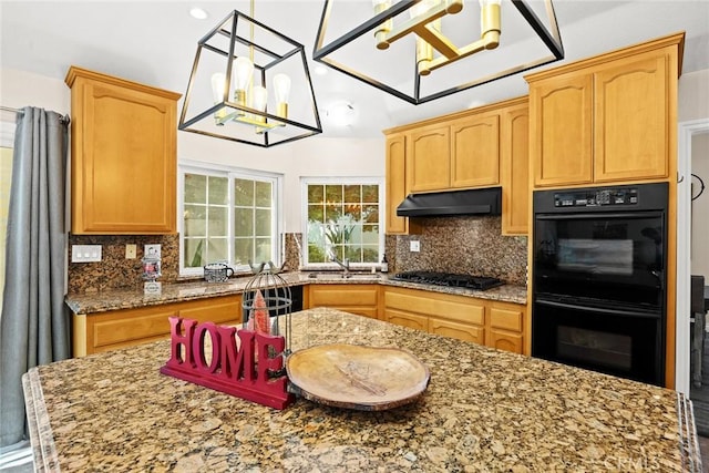 kitchen with light stone countertops, backsplash, sink, black appliances, and a chandelier