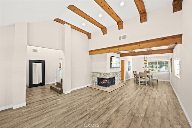 unfurnished living room with lofted ceiling with beams and wood-type flooring