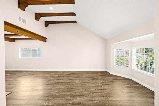 spare room with dark hardwood / wood-style floors and lofted ceiling with beams