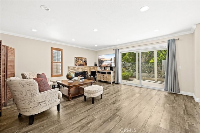 living room with wood-type flooring, a wealth of natural light, and crown molding