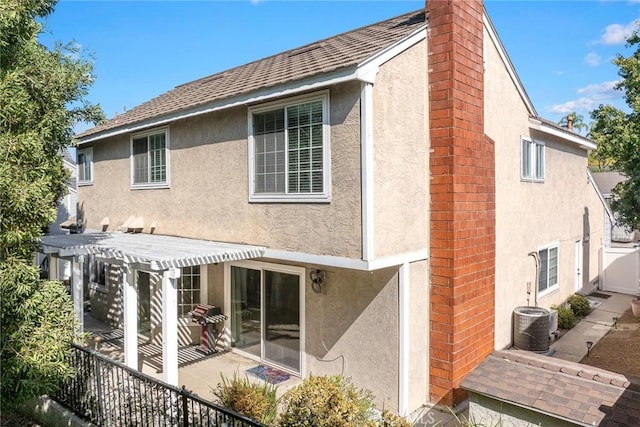 rear view of house featuring a patio and central AC unit