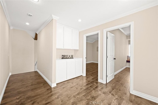 hallway with wood-type flooring and ornamental molding