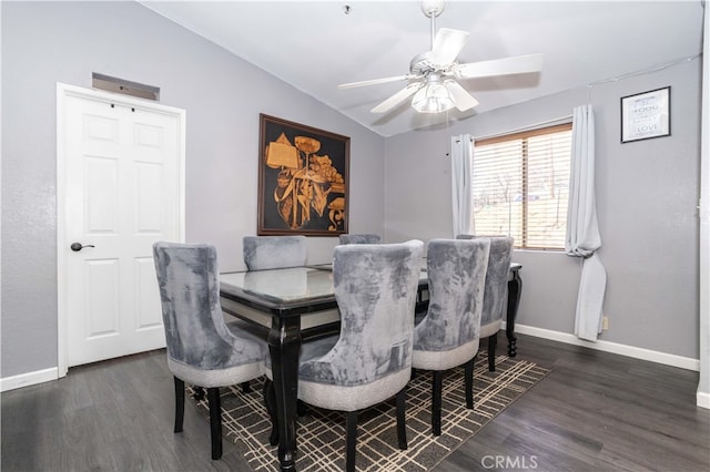 dining space featuring ceiling fan, vaulted ceiling, and dark hardwood / wood-style flooring