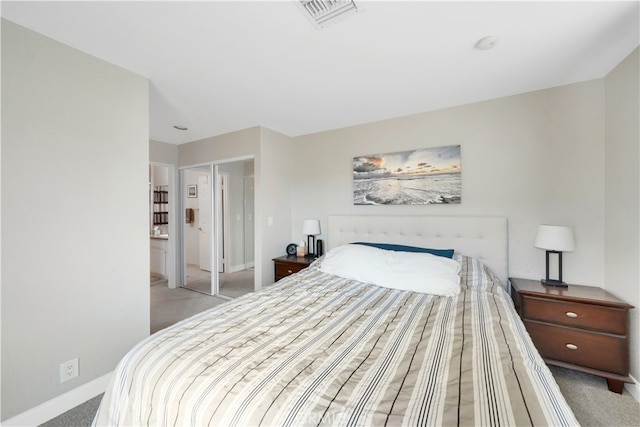 bedroom featuring light colored carpet and a closet