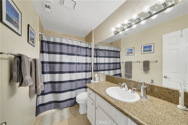 bathroom with tile patterned flooring, curtained shower, vanity, and toilet