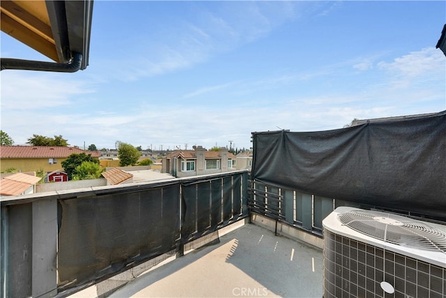 view of patio with cooling unit, a balcony, and area for grilling