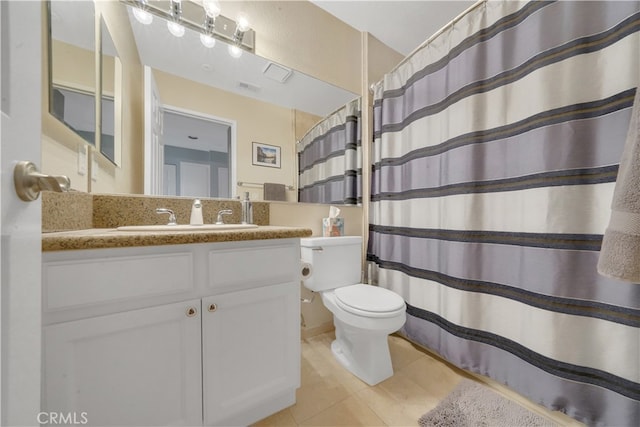 bathroom with curtained shower, tile patterned flooring, vanity, and toilet