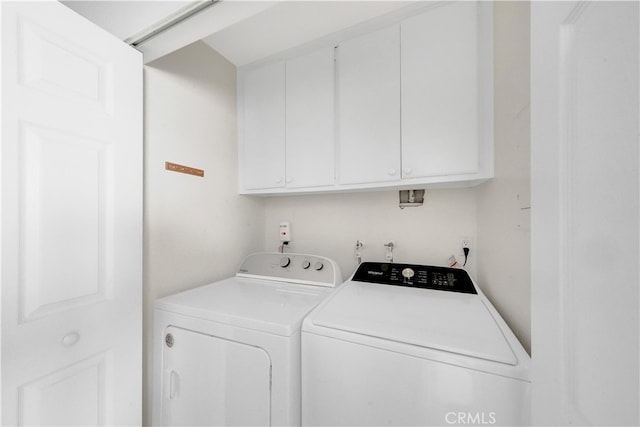 laundry room featuring independent washer and dryer and cabinets