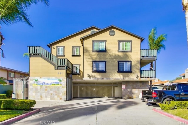 view of front of property with a balcony and a garage