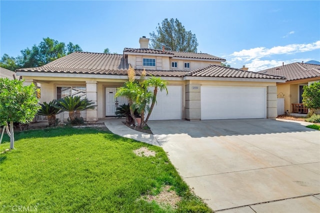 mediterranean / spanish house featuring a front lawn and a garage