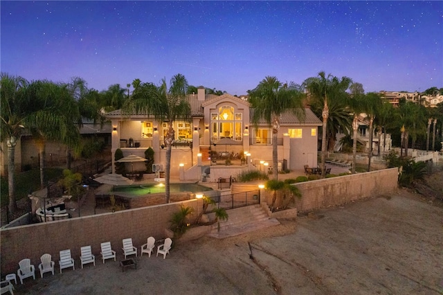 view of front of house with a balcony and a patio area