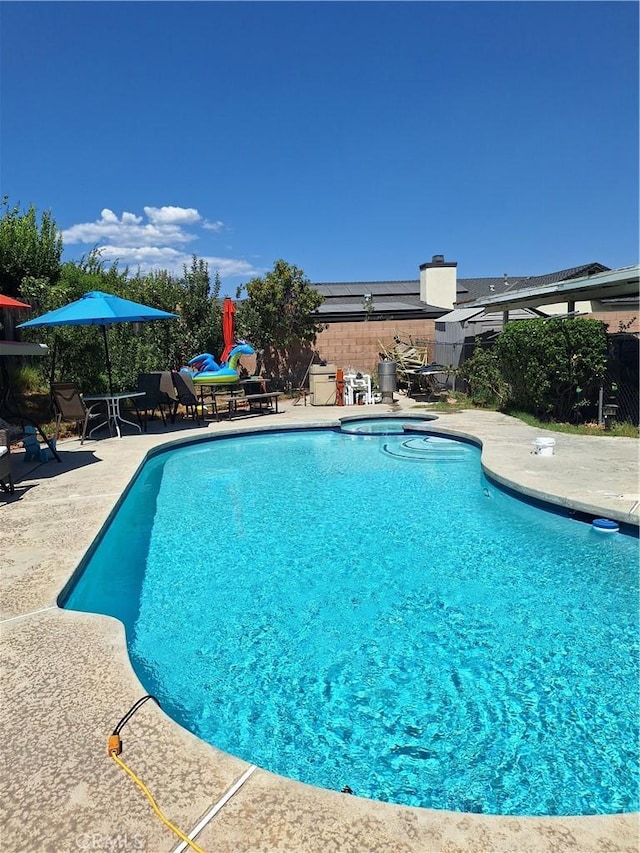 view of pool with a patio, a fenced in pool, and fence