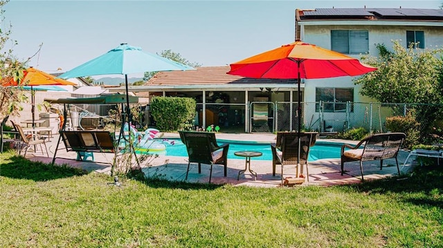 exterior space featuring a yard, a patio, a fenced in pool, and fence