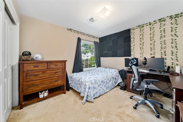 bedroom with light colored carpet and a closet