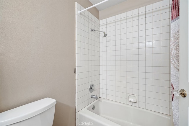 bathroom with shower / bath combo and toilet