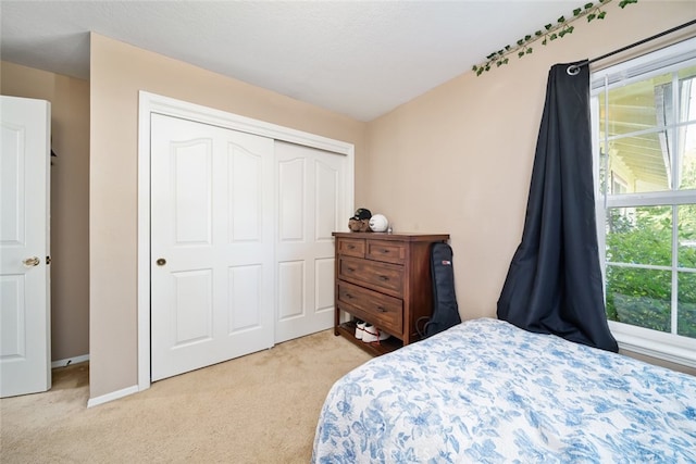 carpeted bedroom featuring a closet