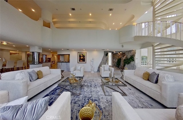 tiled living room featuring a high ceiling