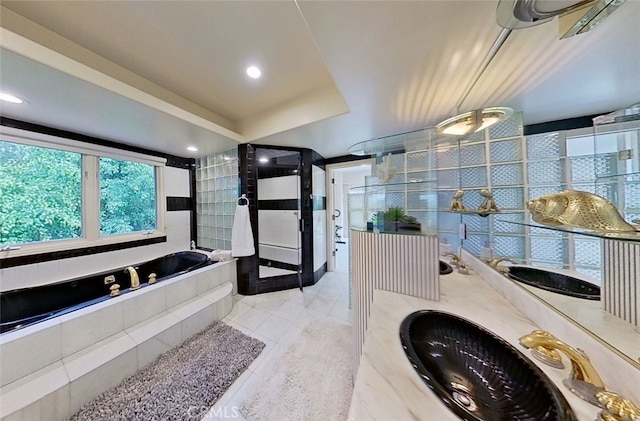 bathroom featuring a relaxing tiled tub and a tray ceiling