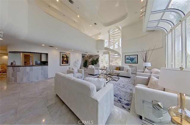 living room featuring a towering ceiling and a raised ceiling