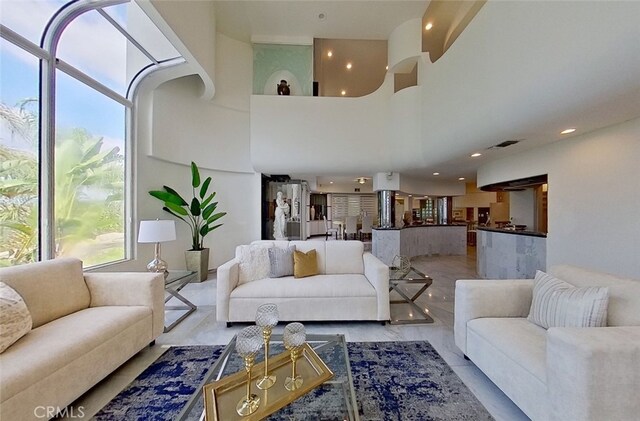 living room featuring a towering ceiling