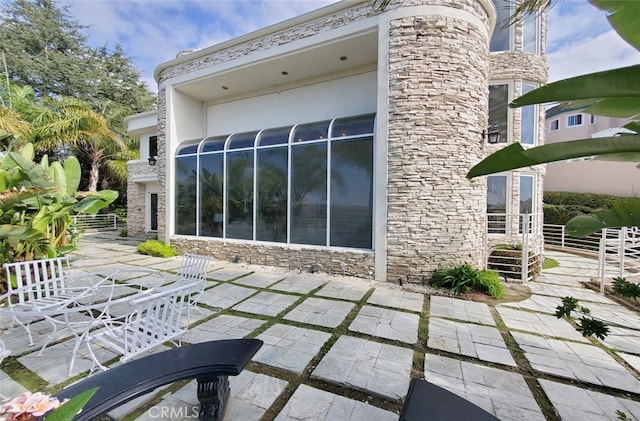 view of side of home with a patio