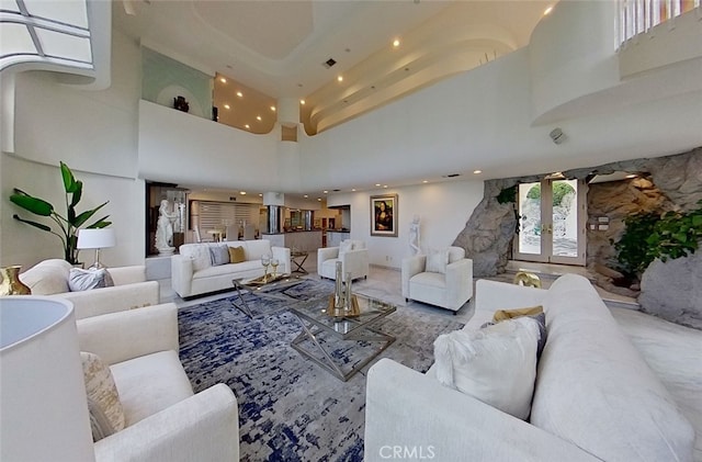 living room featuring a high ceiling and french doors