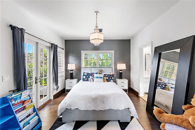 bedroom with access to exterior, multiple windows, and dark wood-type flooring