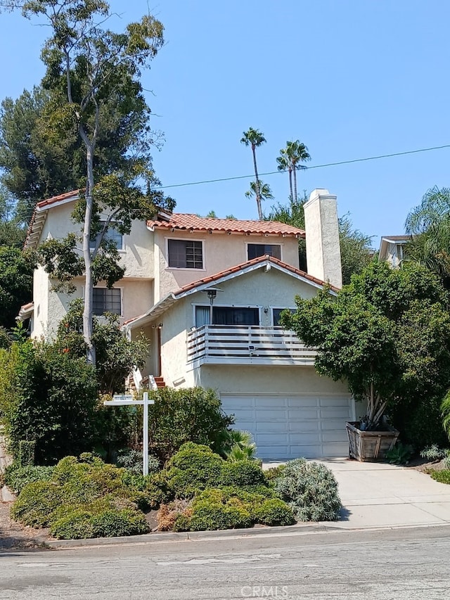 view of front of home featuring a balcony and a garage