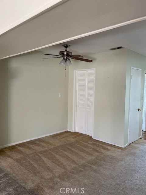 spare room with ceiling fan and carpet