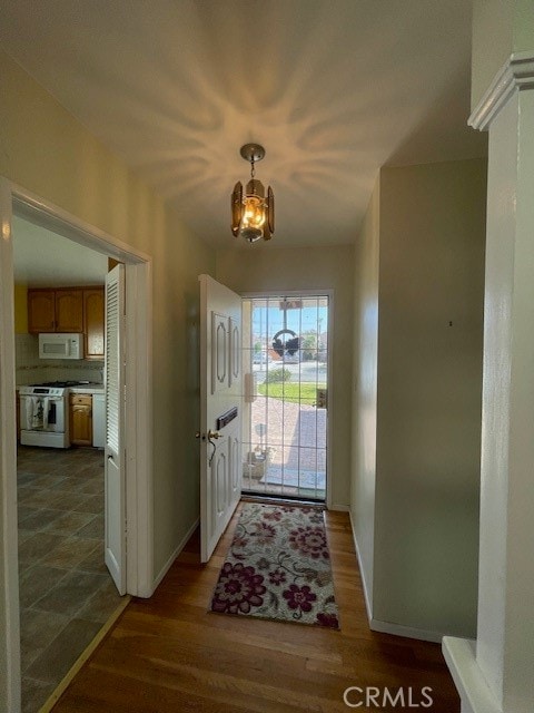 entrance foyer with a chandelier and dark hardwood / wood-style flooring