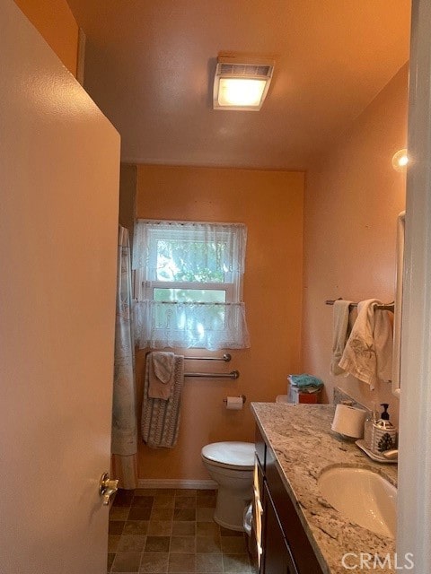 bathroom with vanity and toilet