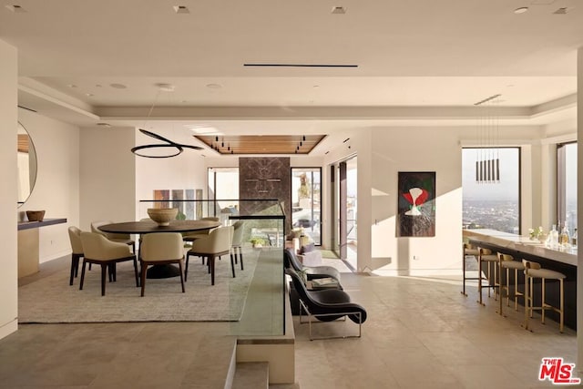 dining space featuring a tray ceiling