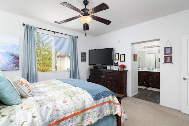 bedroom featuring carpet, ceiling fan, and ensuite bathroom