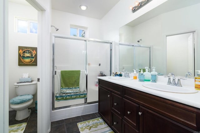 bathroom with walk in shower, vanity, toilet, and tile patterned floors